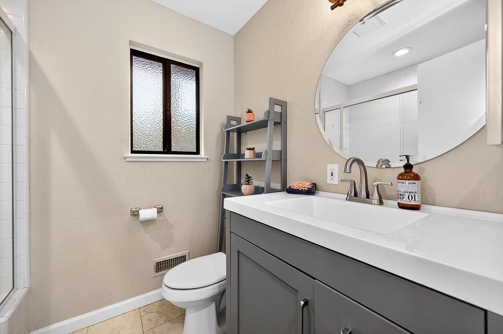 4337 Bannister Road Fair Oaks, CA 95628 - Photo 24 of 35 a bathroom with a sink a toilet and mirror