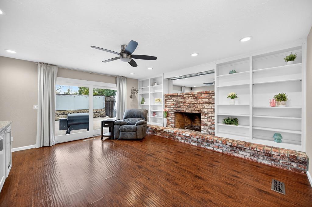4337 Bannister Road Fair Oaks, CA 95628 - Photo 30 of 35 a living room with furniture wooden floor and a fireplace