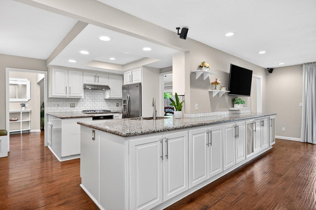 4337 Bannister Road Fair Oaks, CA 95628 - Photo 3 of 35 a large white kitchen with stainless steel appliances granite countertop a sink and cabinets