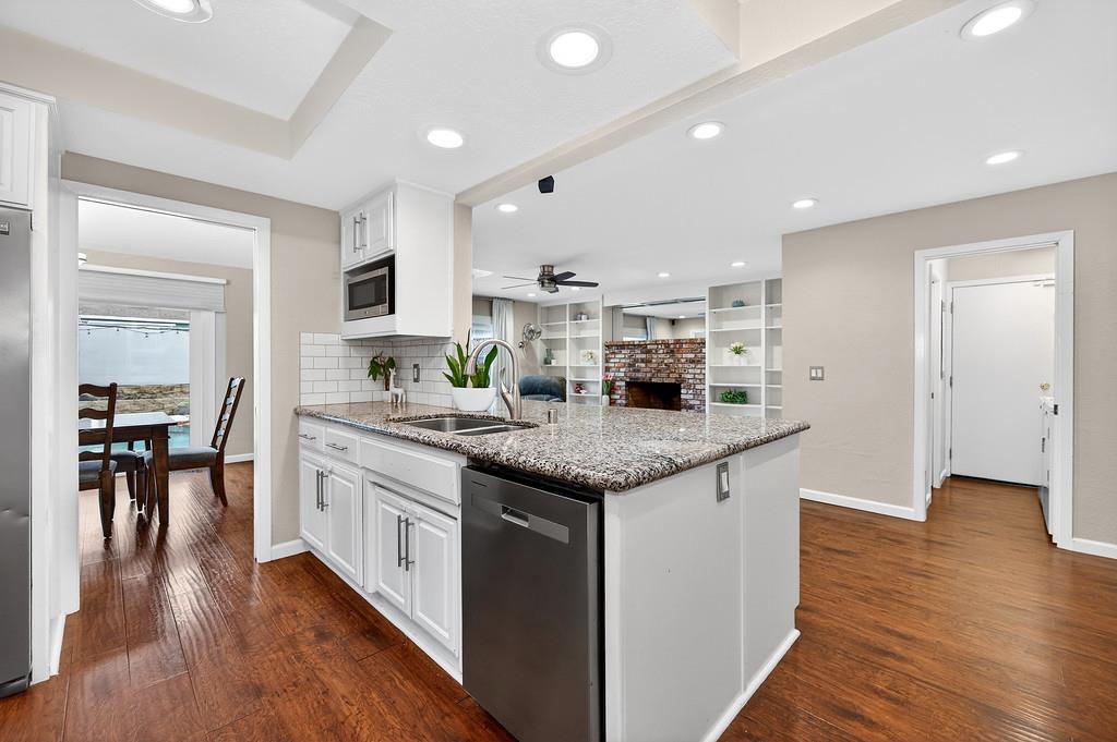 4337 Bannister Road Fair Oaks, CA 95628 - Photo 31 of 35 a kitchen with stainless steel appliances granite countertop a stove and a wooden floors