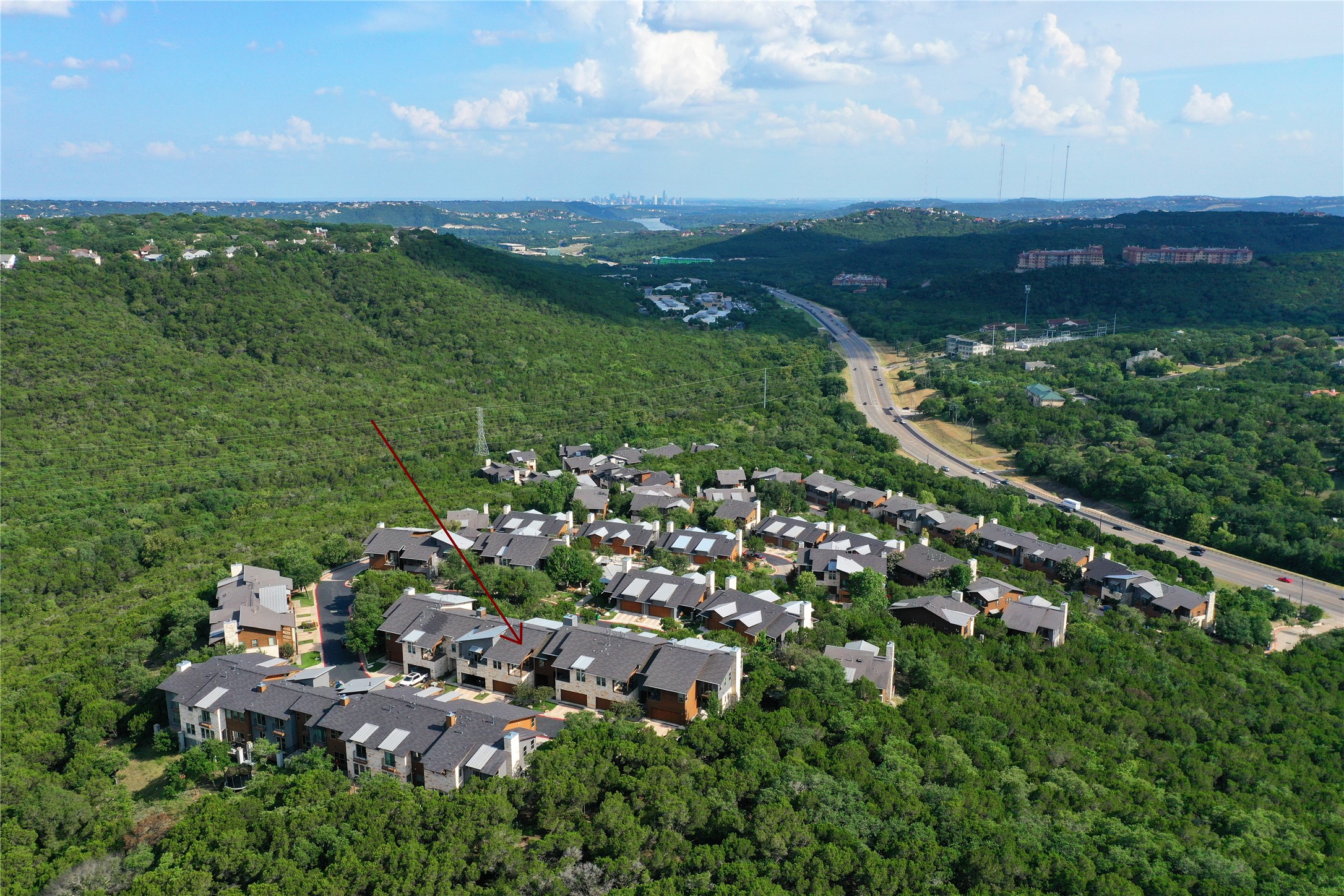 8110 Southeast Ranch Road 2222, Unit 98 Austin, TX 78730 - Photo 29 of 31 Lush rolling hills frame a picturesque neighborhood with sweeping skyline and nature views.