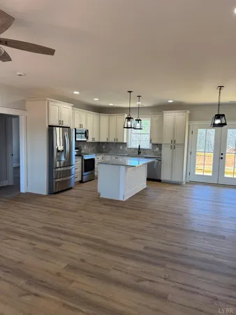 a view of kitchen with wooden floor and refrigerator