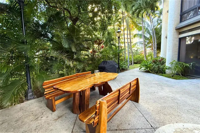 a backyard of a house with table and chairs