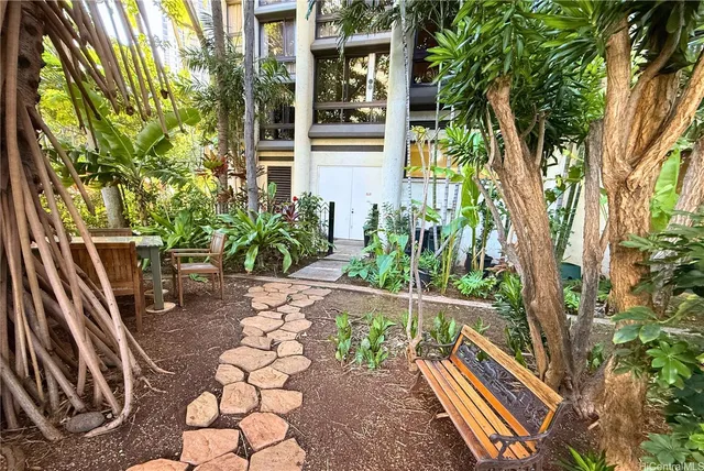 a backyard of a house with table and chairs