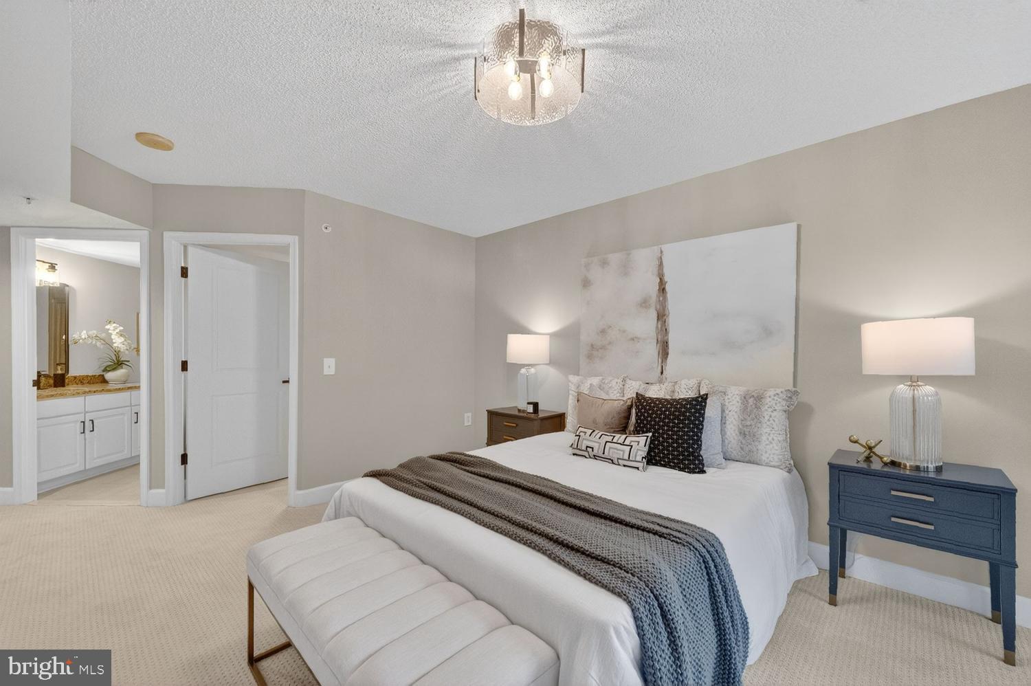 11800 Sunset Hills Road, Unit 314 Reston, VA 20190 - Photo 16 of 50 a bedroom with a bed and a lamp