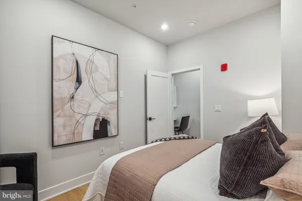 a bedroom with a bed and a window