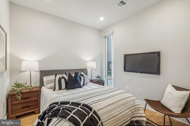 a bedroom with a bed and a television