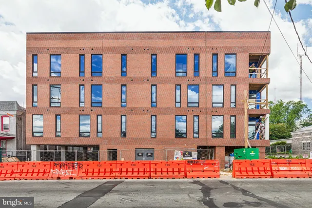 a front view of a residential apartment building with a yard