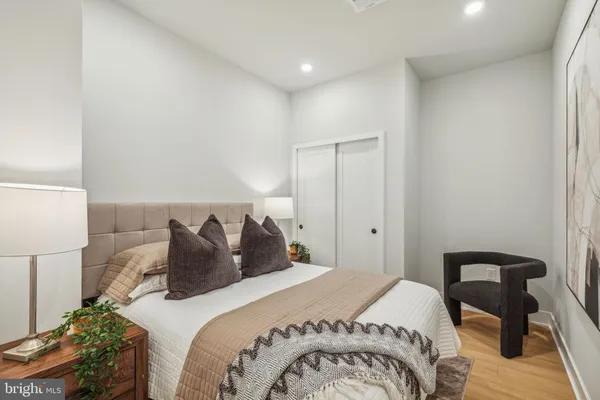 a bedroom with a bed and a lamp on table