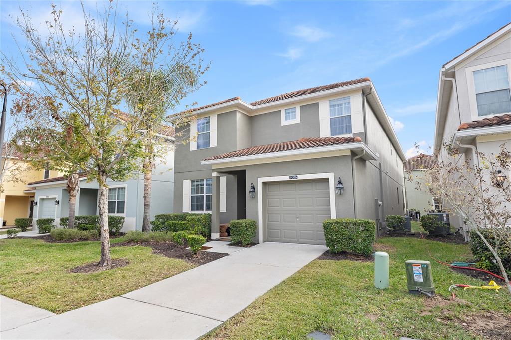 9006 Majesty Palm Road Kissimmee, FL 34747 - Photo 2 of 56 a front view of a house with a yard