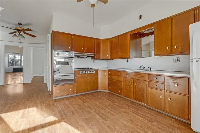 a kitchen with a sink cabinets and wooden floor