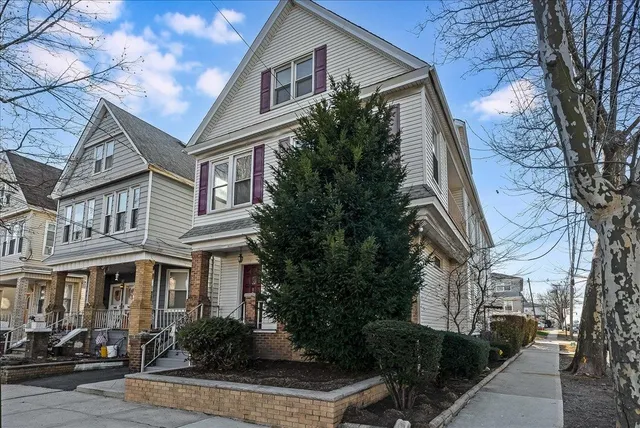 a front view of a residential houses with yard
