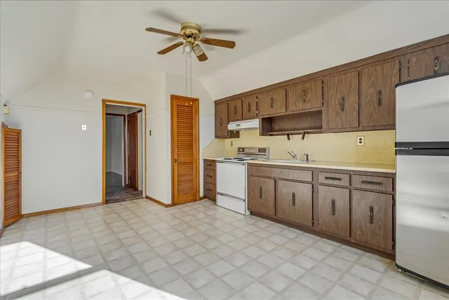 a kitchen with a sink cabinets and appliances
