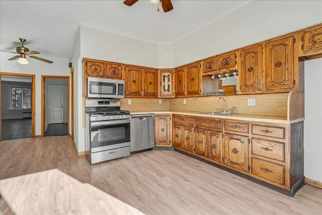 a kitchen with stainless steel appliances granite countertop a stove and a sink