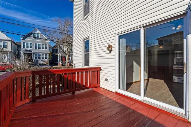 a view of a balcony with two chairs and wooden floor