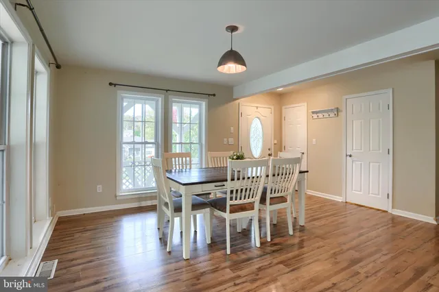 a view of a dining room with furniture window and wooden floor
