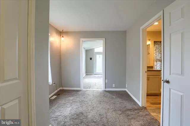 an empty room with windows and closet