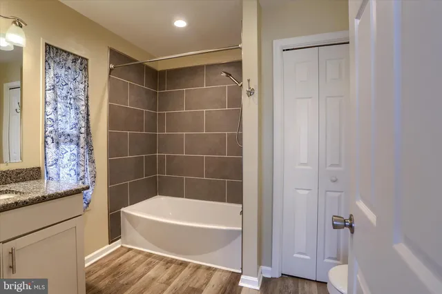 a bathroom with a bathtub and shower