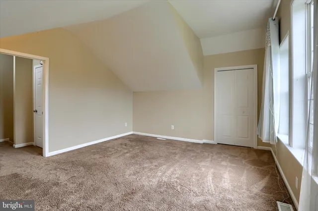 a view of an empty room and a window