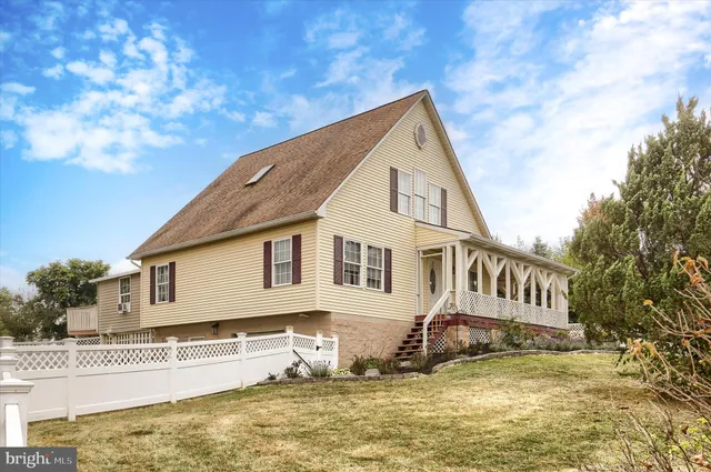 a view of a house with swimming pool and sitting area