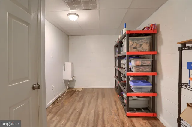 a view of play room with furniture and wooden floor