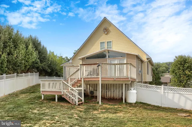 a view of a wooden deck with a yard