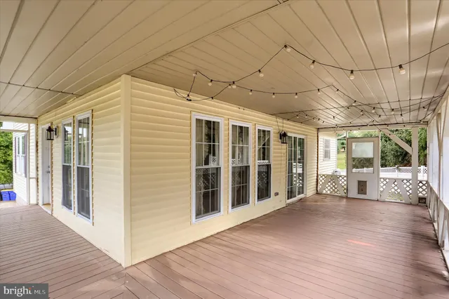 a view of a patio with wooden floor and iron stairs