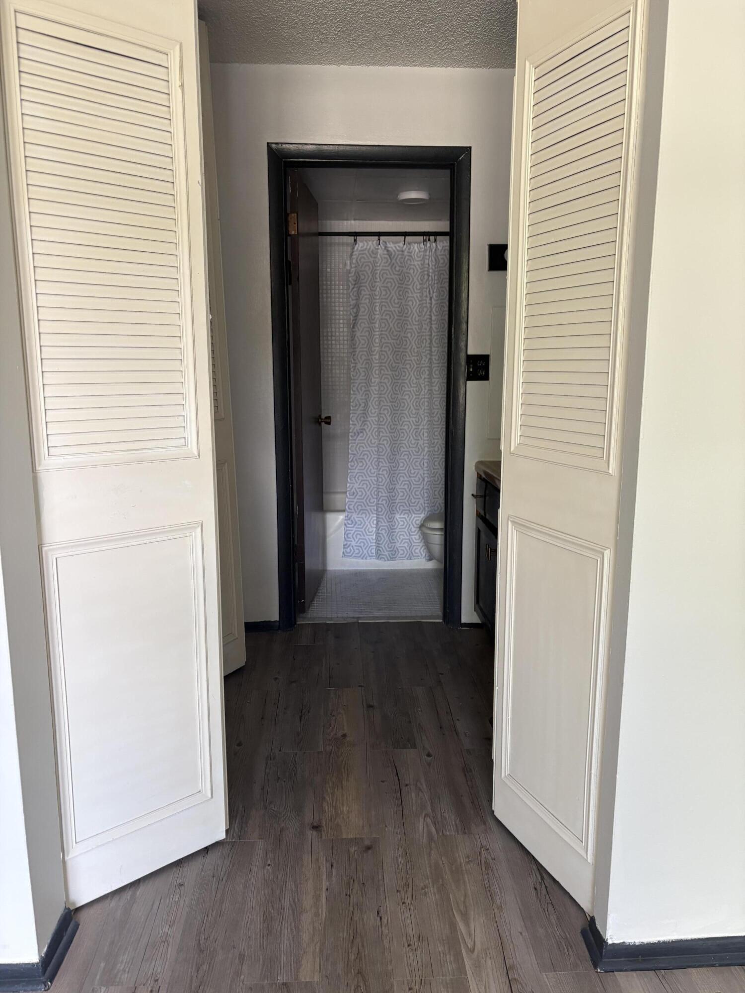 3660 Inverrary Drive, Unit 1B Lauderhill, FL 33319 - Photo 27 of 27 an empty room with wooden floor and windows