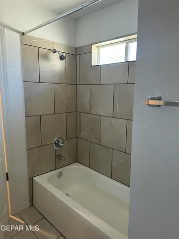 a bathroom with a bathtub and shower