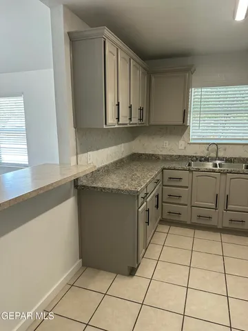a kitchen with stainless steel appliances granite countertop a sink and a stove
