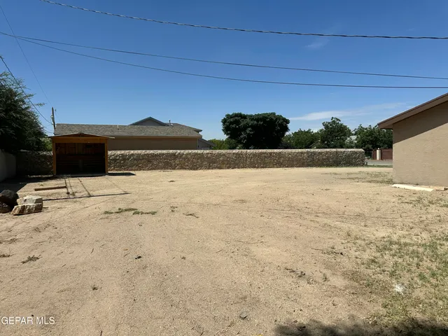 a view of yard with wooden fence