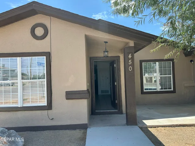 a front view of a house with a blue gate