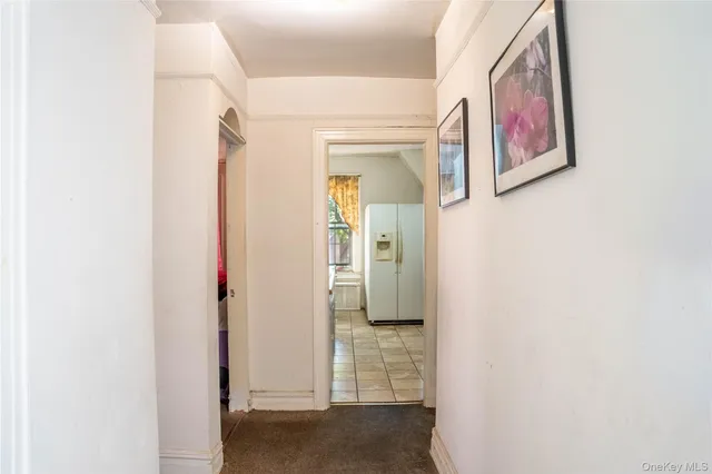 a view of a hallway with paintings on the wall