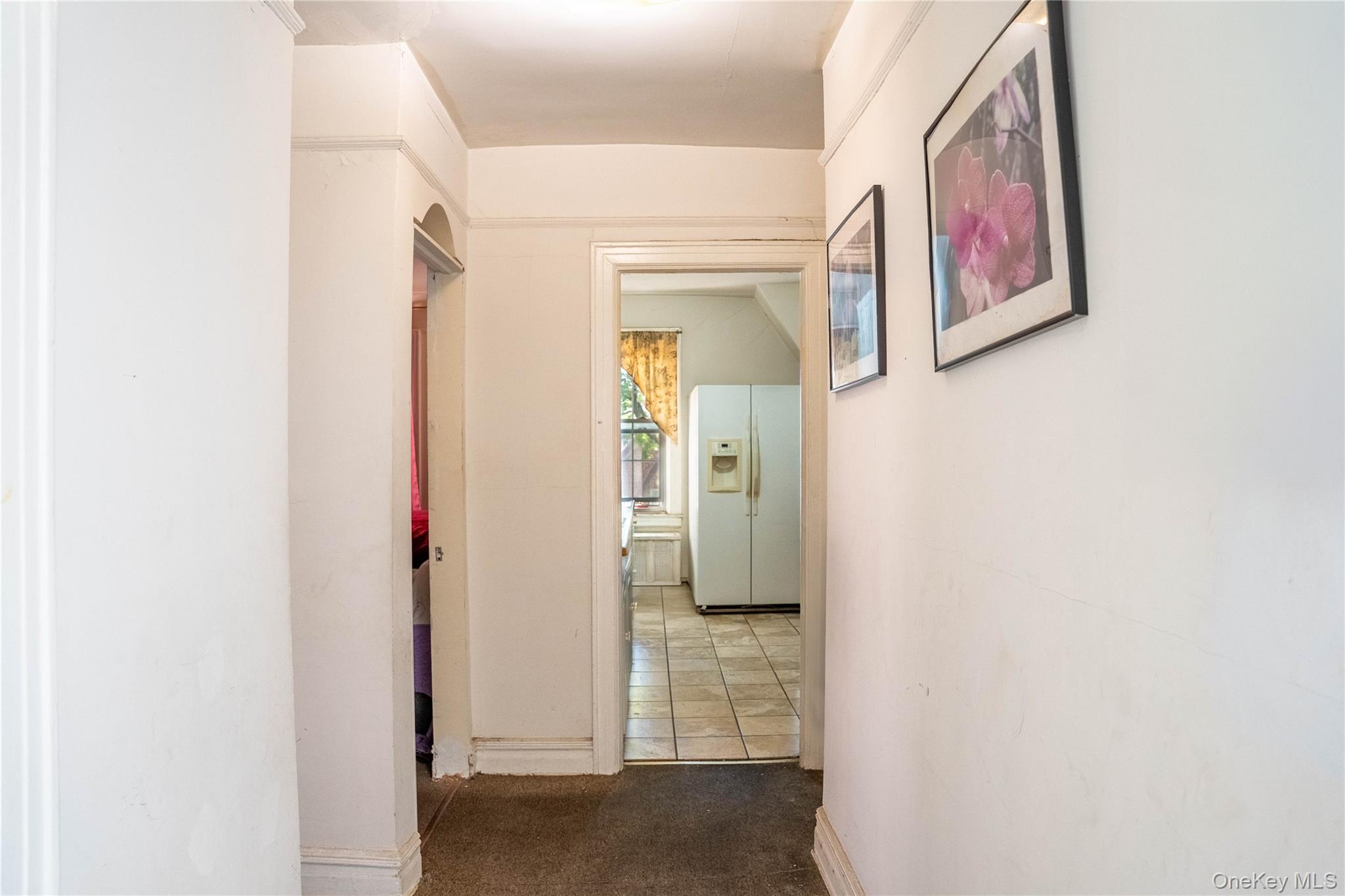 33-26 83rd Street Queens, NY 11372 - Photo 12 of 19 a view of a hallway with paintings on the wall
