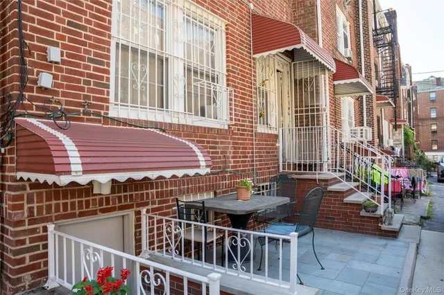 a roof deck with table and chairs and potted plants