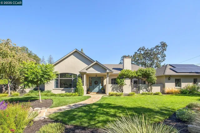 a front view of a house with a yard table and chairs