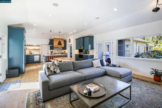 a living room with furniture and a view of kitchen