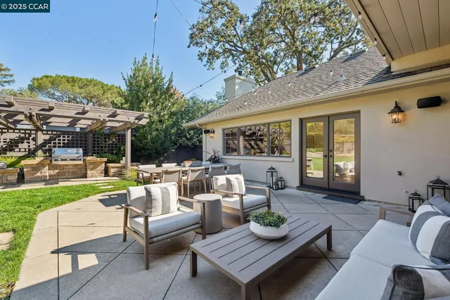 a outdoor space with patio the couches and a dining table with garden view