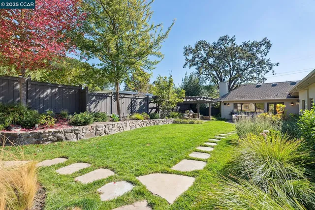 a view of a house with a yard and sitting area