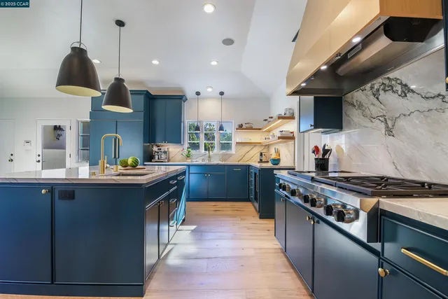 a kitchen with stainless steel appliances granite countertop a stove and a sink