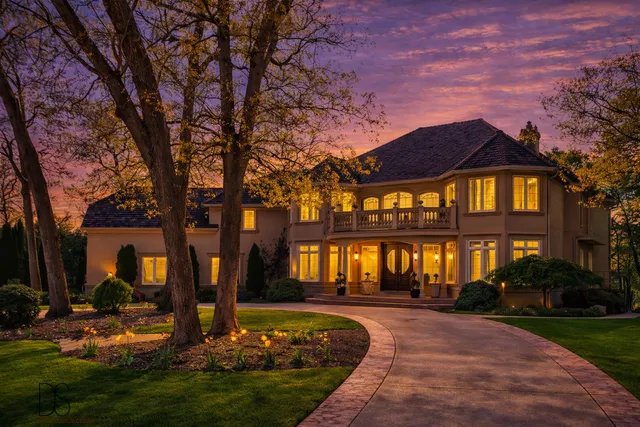 a front view of a house with a yard table and chairs