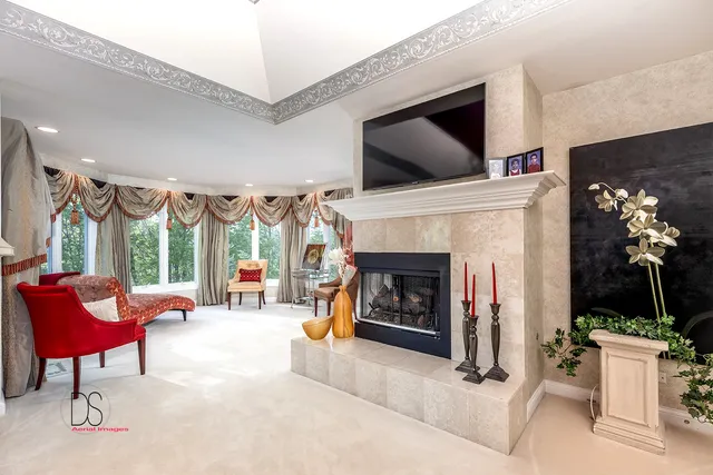 a view of a patio with a table and chairs and floor to ceiling window