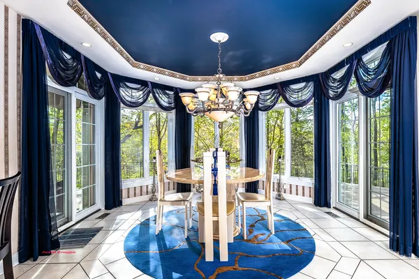 a view of a dining room with furniture large windows and wooden floor