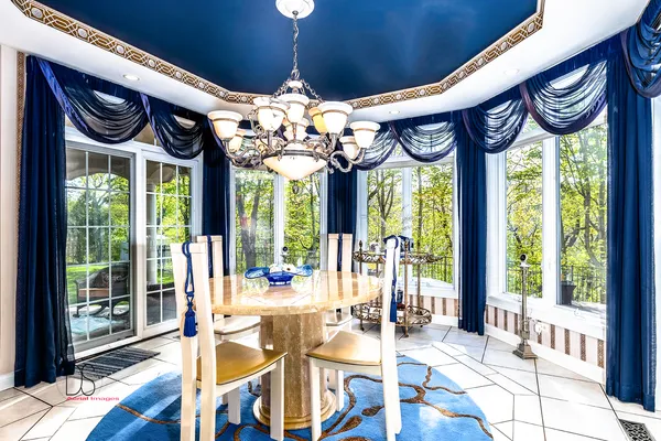 a kitchen with a table chairs refrigerator and cabinets