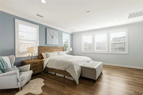 a bedroom with a bed couch and window