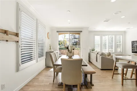 a dining room with furniture and wooden floor