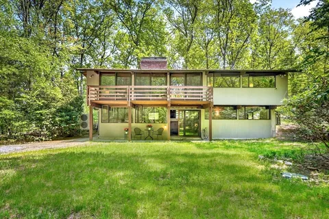 a view of a house with a yard and sitting area