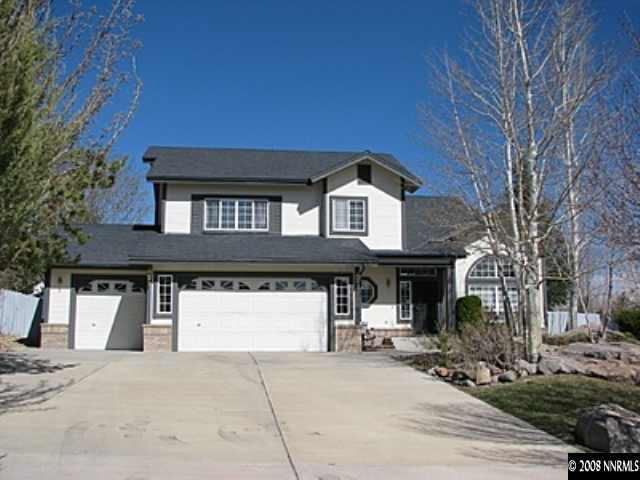 a front view of a house with garage