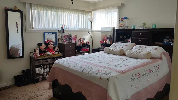 a bed room with a bed and a window