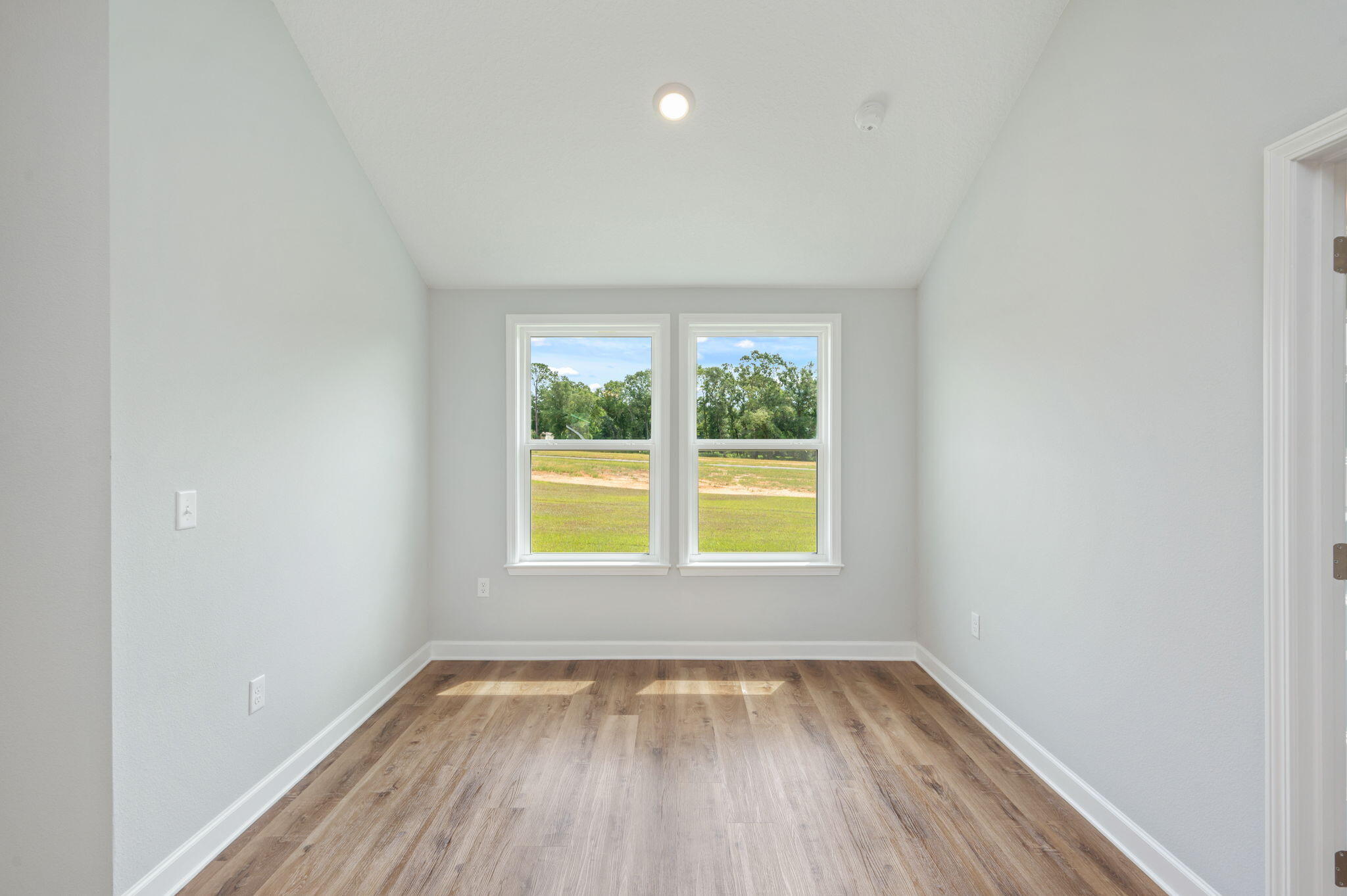 3851 Poverty Creek Road Crestview, FL 32539 - Photo 13 of 32 an empty room with a window and wooden floor